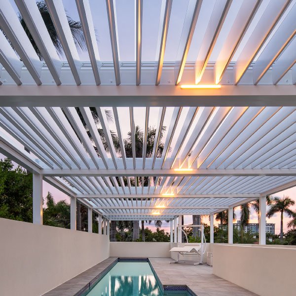 Rooftop pool with closed louvered roof at dawn - South Florida